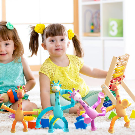 Two children playing with colorful toy giraffes on a carpeted floor.